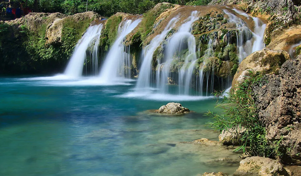 Bolinao Falls 2 with wide shallow pools surrounded by lush greenery
