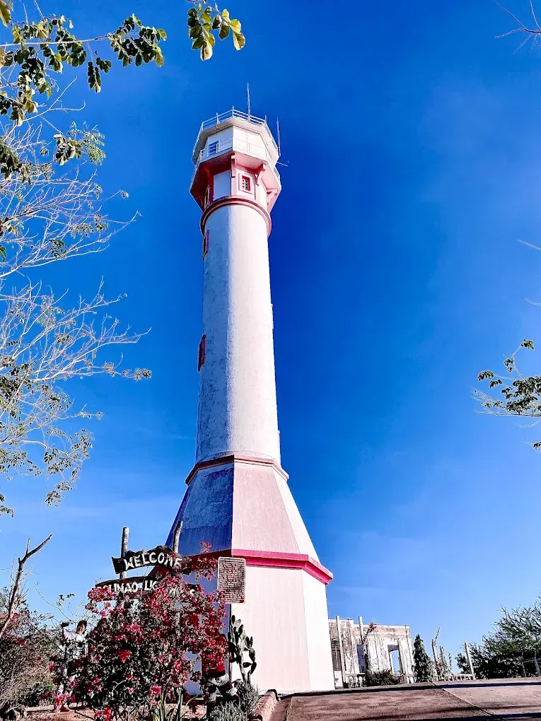 Cape Bolinao Lighthouse standing tall against a scenic coastal backdrop